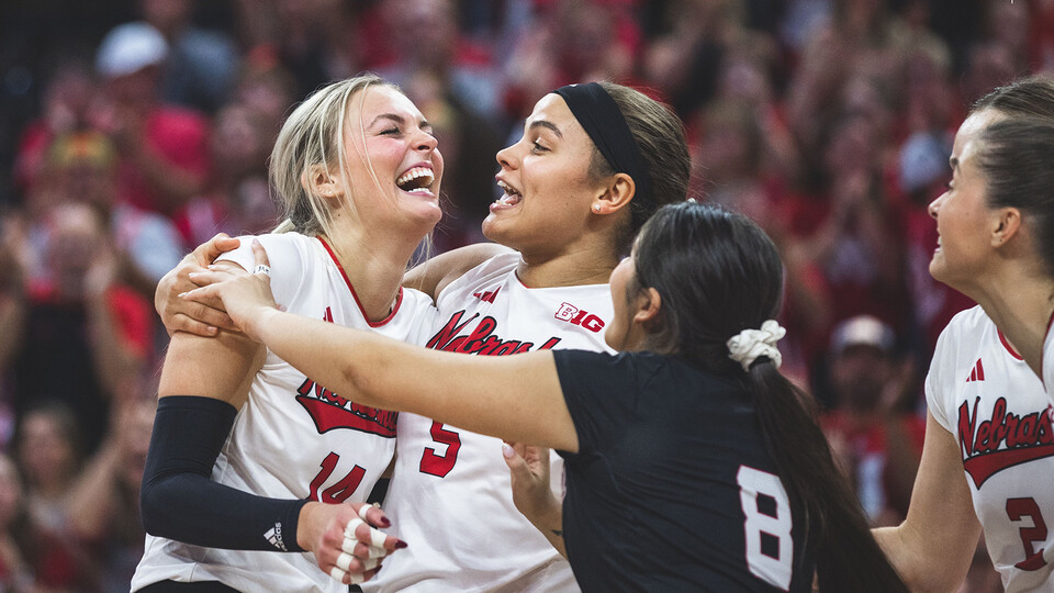 Husker volleyball player Ally Batenhorst receives a hug from Kennedi Orr and Lexi Rodriguez