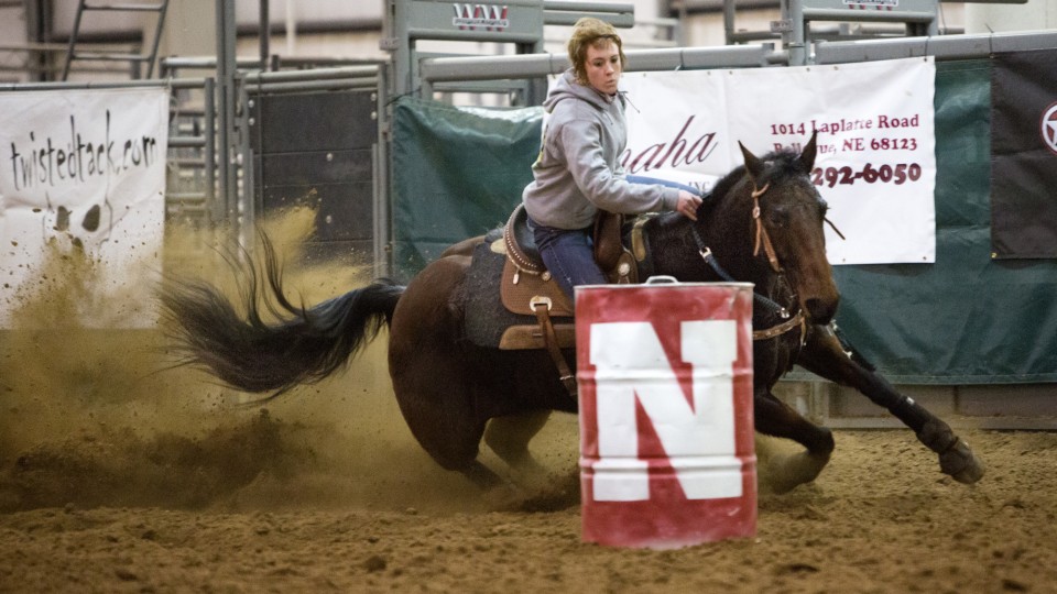 Sam Asmus, a sophomore agribusiness major, and her horse concentrate as they round the first of three barrels during a practice run.