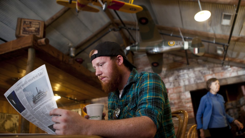 A customer enjoys a cup of coffee at the Grind Coffee Shop in Lincoln's Haymarket. A survey completed in March showed Nebraska businesses remain positive about Nebraska's economy.