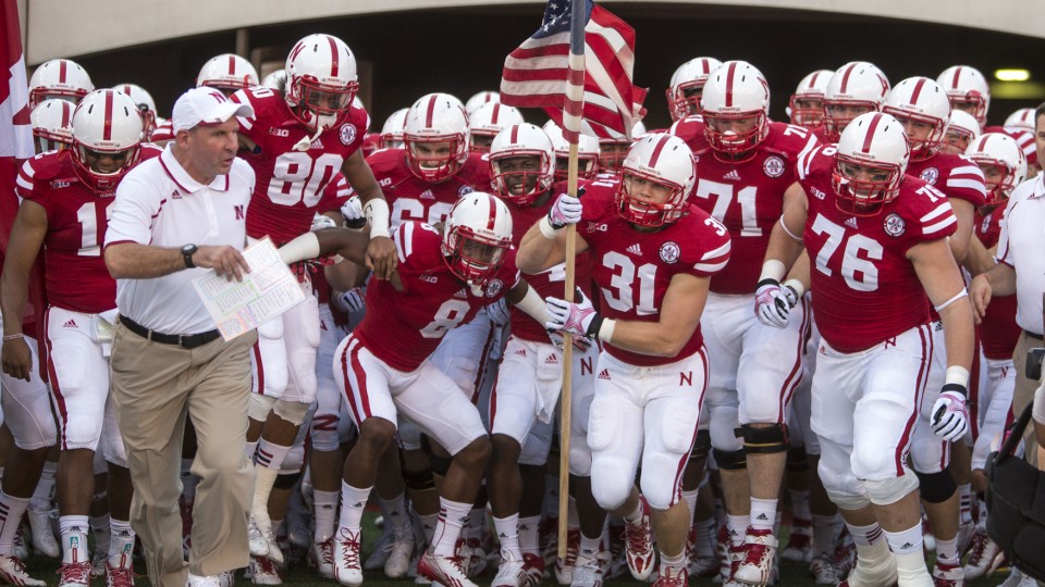 C.J. Zimmerer leads the Huskers out of the tunnel and onto the field during the Aug. 31, 2013 game against Wyoming.