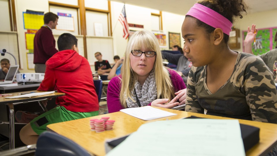 Megan Jorgensen, a UNL graduate, discusses a math problem with a student at Park Middle School in this file photo from 2014. UNL will use a $1 million Nebraska Department of Education grant to improve K-12 math and science instruction statewide.