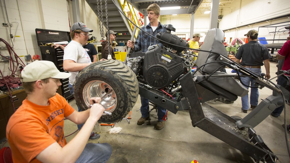 UNL students build a quarter-scale tractor prototype in this file photo. A recent review of the Nebraska economy, which showed modest drops in manufacturing hours and building permits for single-family homes, indicates a cooling in early 2017.
