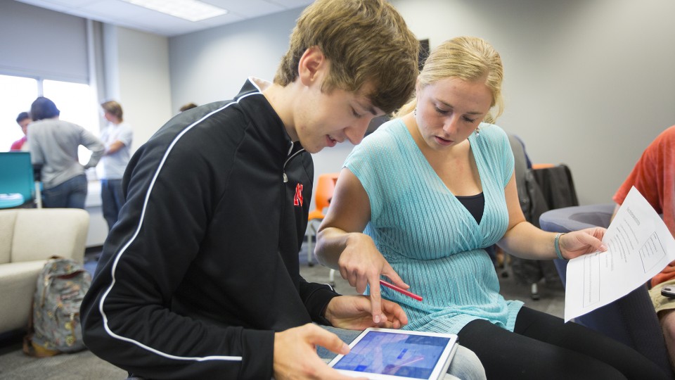 Kaylee Barber (right), a graduate teaching assistant, explains how to use the new iPads in UNL's renovated Language Lab. Located in Burnett Hall, the lab will host an open house on Oct. 3.
