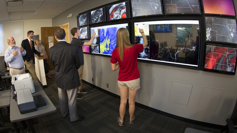 Clint Rowe (left) and Adam Houston (second from left) showcase the touchscreen video wall in UNL's recently remodeled Meteorology-Climatology Computer Lab in Bessey Hall. Rowe and Houston are participating in a two-day Weather Day on the Hill summit in Washington, D.C.
