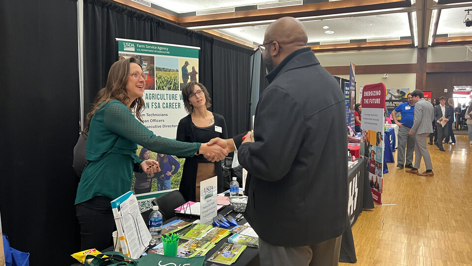 Chancellor Rodney Bennett greets employees from the U.S. Department of Agriculture while dropping in on a career fair