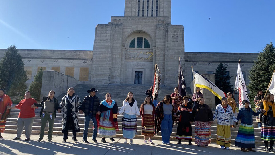 Native Americans sing in front of the Nebraska Capitol while celebrating Indigenous Peoples' Day