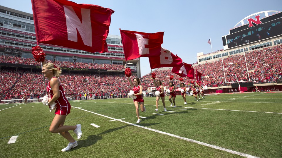 The Huskers' cheer squad runs across Tom Osborne Field in Memorial Stadium during the 2015 Red-White Spring Game. Kickoff for the 2016 game is 1 p.m. April 16.