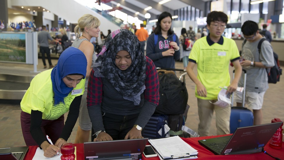 Sharon Al-Badry (left) helps s a Raihana Hassim register her arrival at UNL in the Lincoln airport on Aug. 17. Al-Badry, a sophomore chemical engineering major from Lincoln, is part of UNL's new international student welcome team.