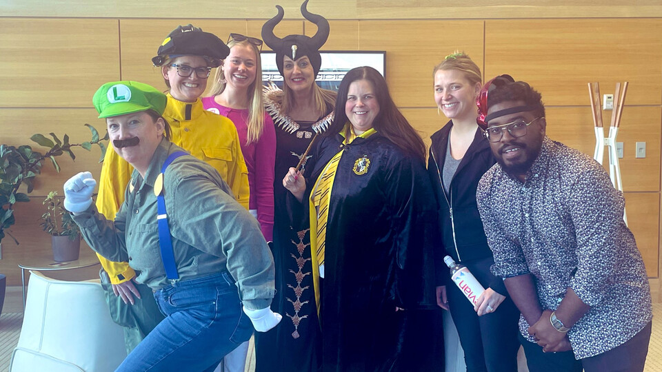 Huskers from the College of Business pose while dressed up as Luigi, Maleficent and other famous figures