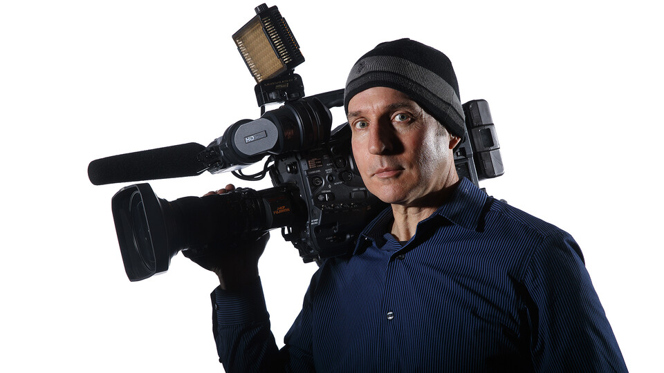 Photo of David Fitzgibbon holding a video camera.