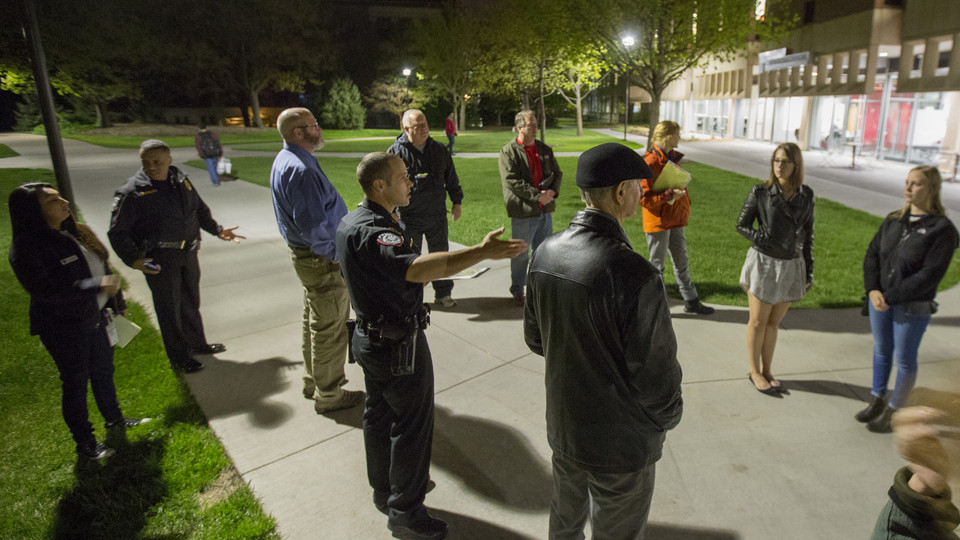.Capt. John Backer of the University Police Department discusses lighting and landscaping improvements made to increase visibility on the plaza north of Love Library. The discussion was part of the university annual campus safety walk, which was held April 27.