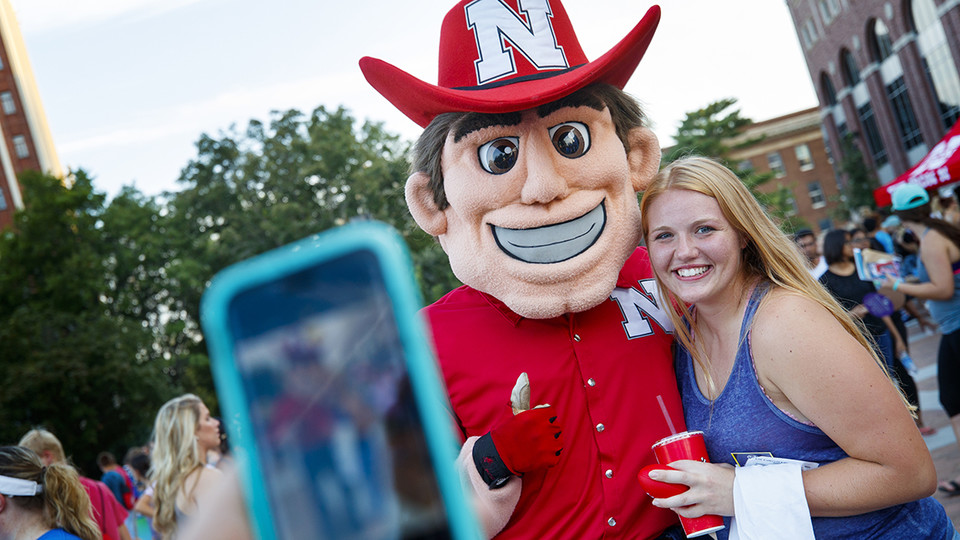 Nebraska’s Kristin Rice poses with Herbie Husker at the Big Red Welcome Street Fest on Aug. 20. New semester celebrations continue with the Back to School Bash on Aug. 25.