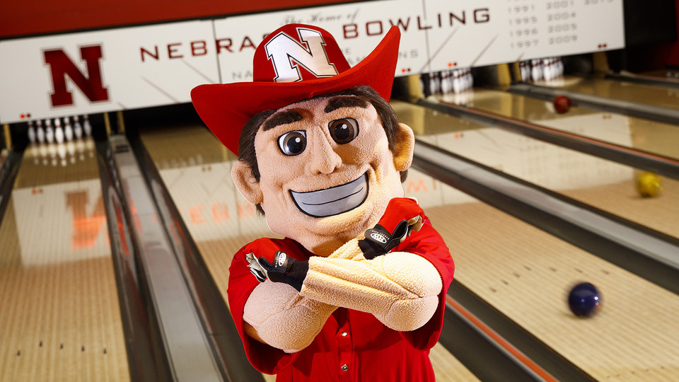 Herbie Husker throws the bones at Lanes 'n Games in the East Union. The photo is is featured as the April image in the Nebraska Alumni Association's 2018 calendar.