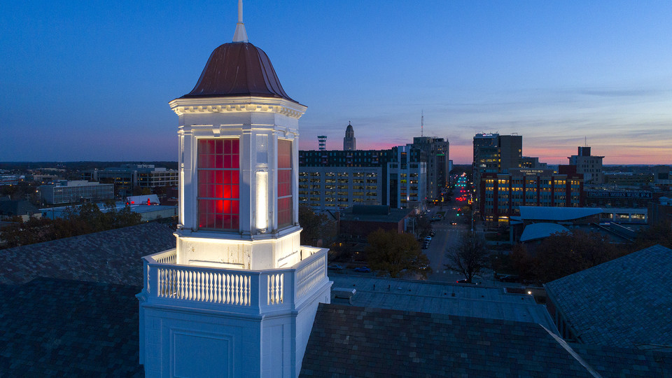 The sun sets as Nebraska's Love Library cupola glows over downtown Lincoln. Chancellor Ronnie Green announced Dec. 5 that the university will not be moving forward with additional proposed budget cuts.