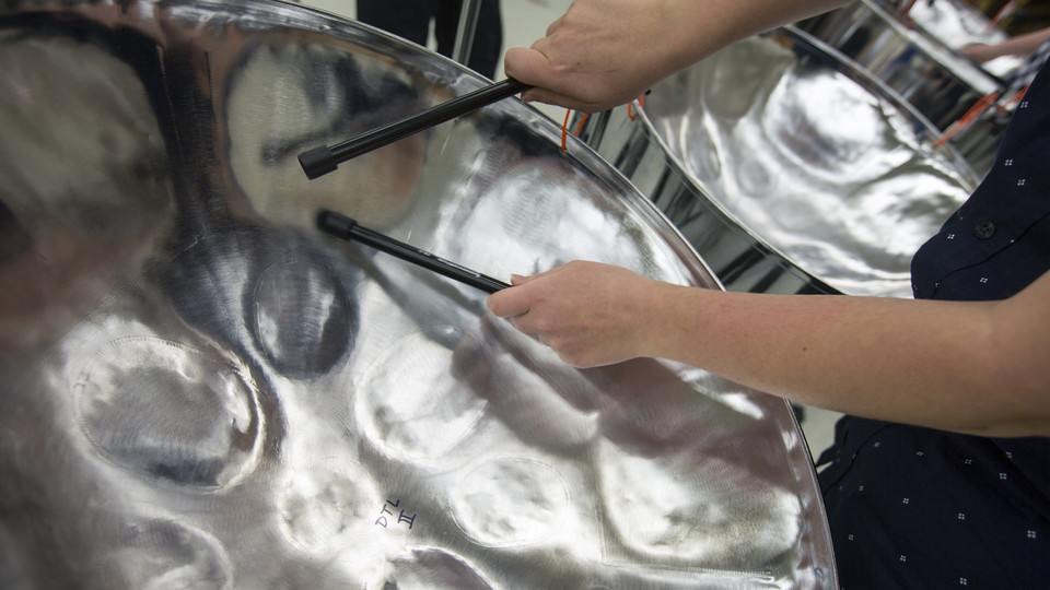A member of Nebraska Steel plays a pan during practice in Westbrook Music Building. Pans — also known as steel drums — feature hammered areas that when struck with a mallet play a specific note. Different styles of pans operate as “voices” within an ensemble and, when combined, work together like a choir.