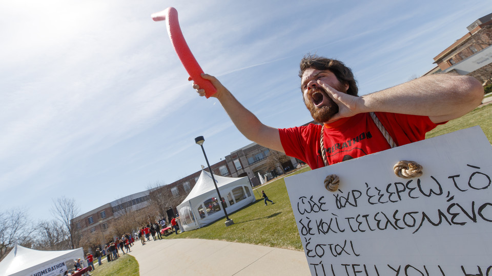Dylan Severino, senior in classical languages, wears a gyro sign as he calls out to fellow students to attend the Homerthon. The university’s first-ever Homerathon — a marathon reading of “Iliad” — will begin 7 a.m. April 19 on the Meier Commons green space north of the Nebraska Union. It is expected to wrap at 4 a.m. April 20.  April 19, 2019.
