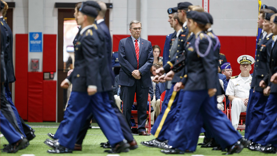 Chancellor Ronnie Green watches as Nebraska ROTC cadets walk by during the annual chancellor's review on April 26 in Cook Pavilion.