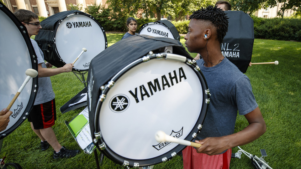 Bass drummers practice in the shade around Louise Pound Hall on Aug. 10. The Cornhusker Marching Band drummers are an annual signal to the end of summer and start of the fall semester.