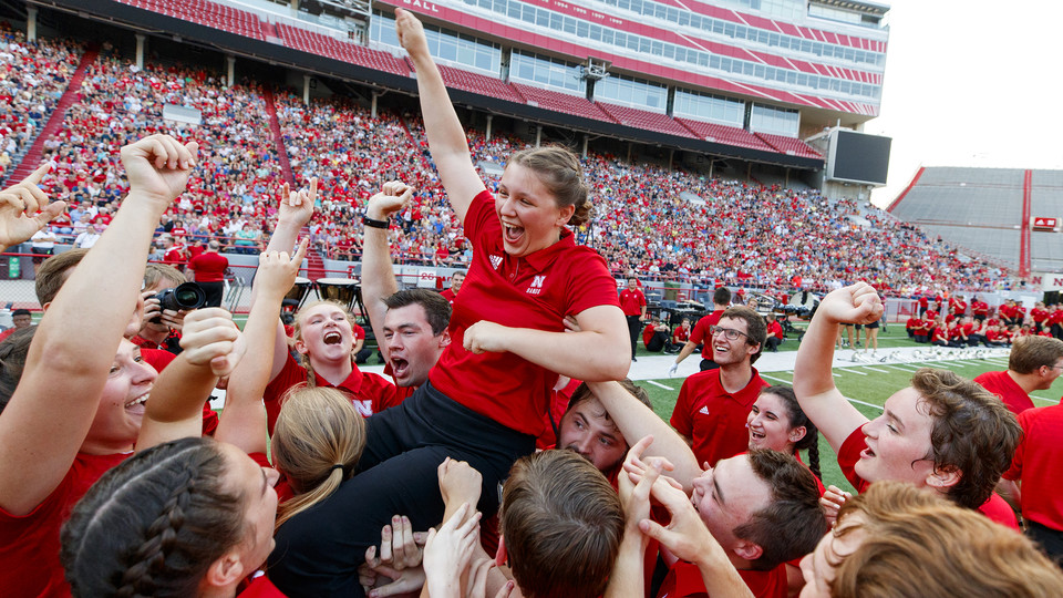 Band members celebrate by lifting Sophia Kallas of Green Bay, Wisconsin, after the junior mellophone player won the march off competition at the Cornhusker Marching Band exhibition on Aug. 17.