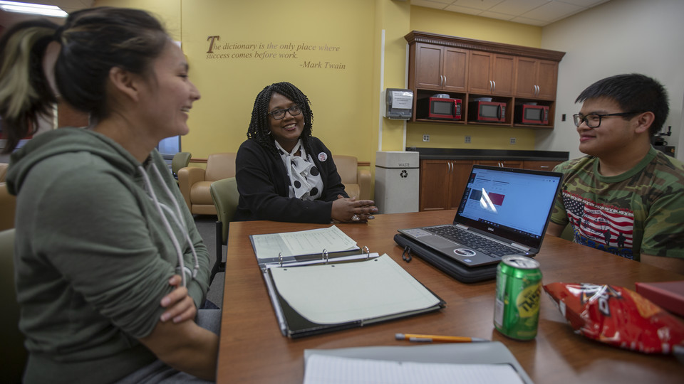 Nebraska's Charlie Foster (center) talks with Huskers Angelica Solomon and Anthony Vu in the OASIS study lounge. Foster was awarded the 2019 Chancellor's Fulfilling the Dream award.