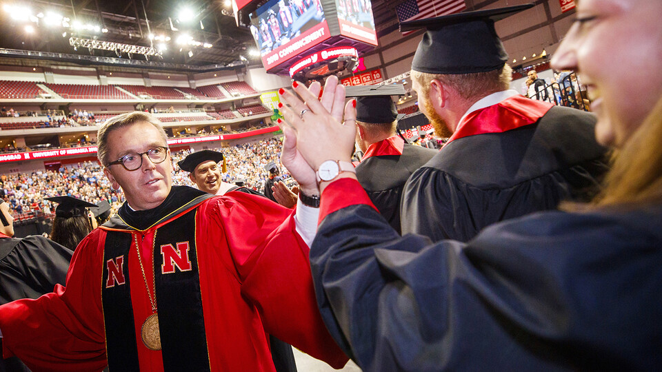Chancellor Ronnie Green gives a high five during commencement on May 4, 2019 in Pinnacle Bank Arena. Green is retiring today after seven years of service as the university's leader.