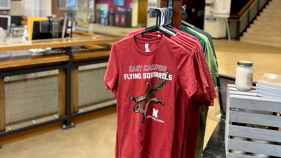 T-shirts featuring flying squirrels hang in the Maps & More store.