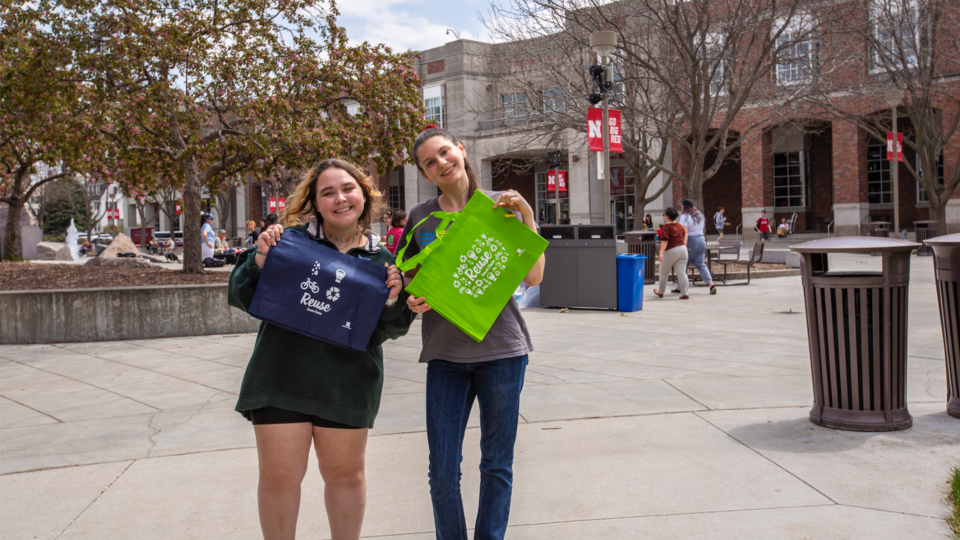 University of Nebraska–Lincoln students holding reusable bags outside of the EarthStock earth day block party