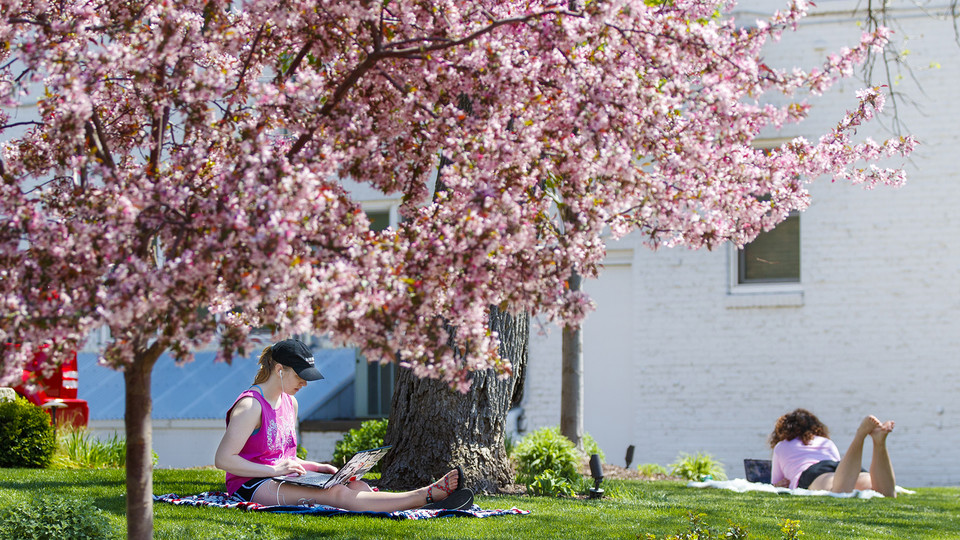 Kelsey Eihausen (from left), a sophomore from Bennington, and Molly Sambol, a junior from Omaha, study outside of the Phi Mu sorority on April 27.