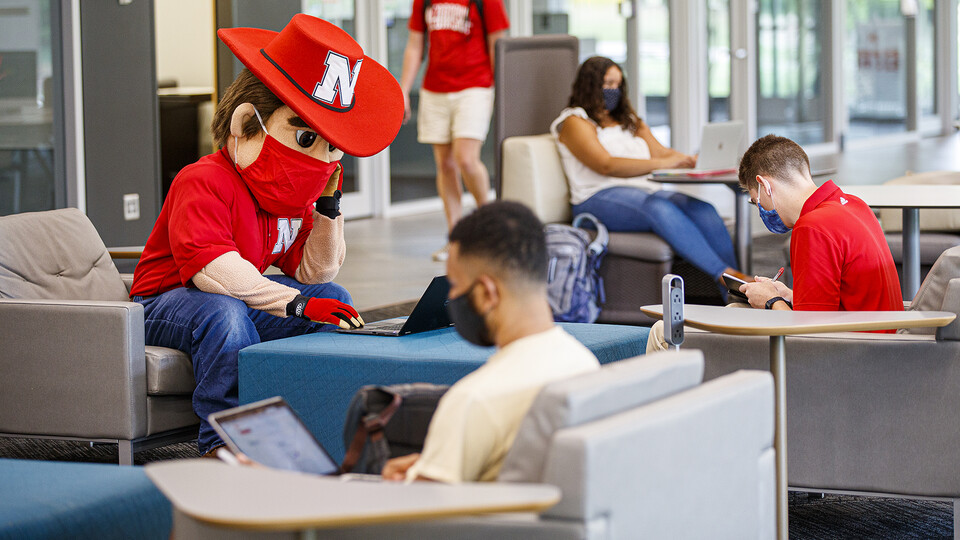 Herbie Husker types out an email in Adele Coryell Hall Learning Commons at the start of the fall 2020 semester. A small group of Huskers has been answering pandemic emails since March 11, 2020.