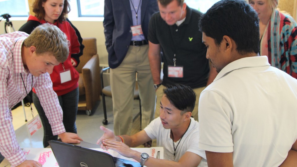  Team members discuss a mobile app business called CornSoyWater during the 3DS Engler Startup Experience.