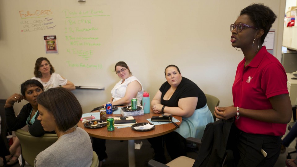 Mecca Slaughter (right), a UNL admissions employee, speaks during a "Dish It Up" conversation July 15 at the Jackie Gaughan Multicultural Center.
