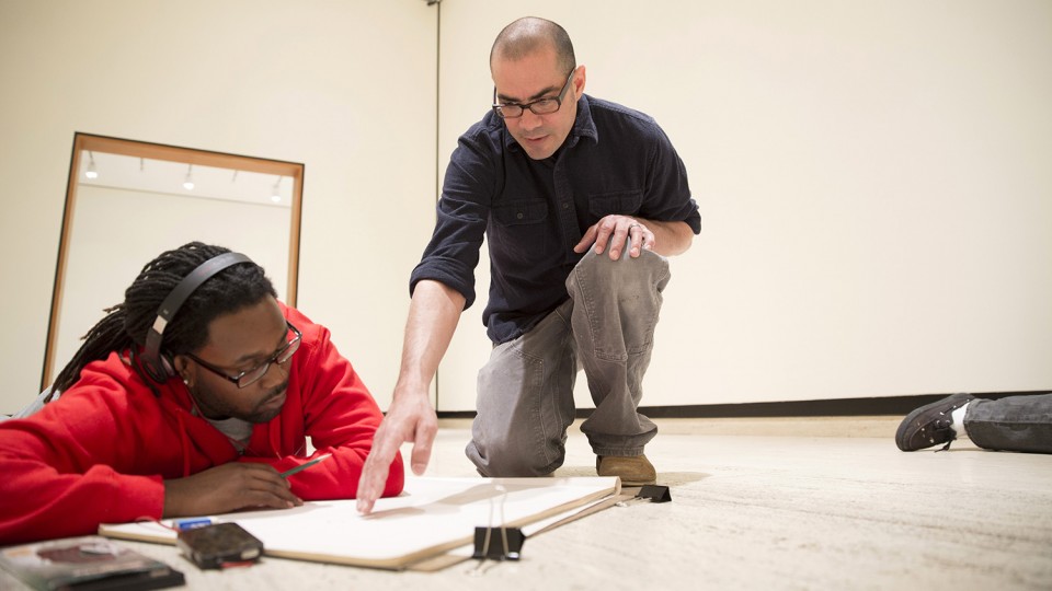 Santiago Cal, associate professor of art at UNL, works with a student in May 2013. UNL's Department of Art and Art History has been renamed the School of Art, Art History and Design.