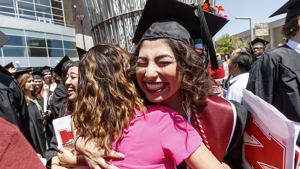 Clarisa Almazan receives a hug after the undergraduate commencement ceremony May 6 at Pinnacle Bank Arena. She received a Bachelor of Science in Education and Human Sciences.