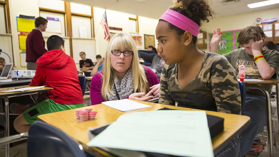 Megan Jorgensen, a University of Nebraska-Lincoln graduate, discusses a STEM problem with a student at Lincoln's Park Middle School in this file photo from 2014.