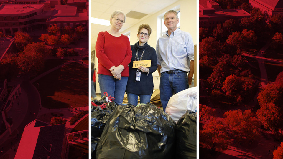 Nebraska's Dee Ebbeka (left) and John Carroll (right), representing the School of Natural Resources, and Linda Kern of Clinton Elementary, pose with this year's Coats for Clinton donation.
