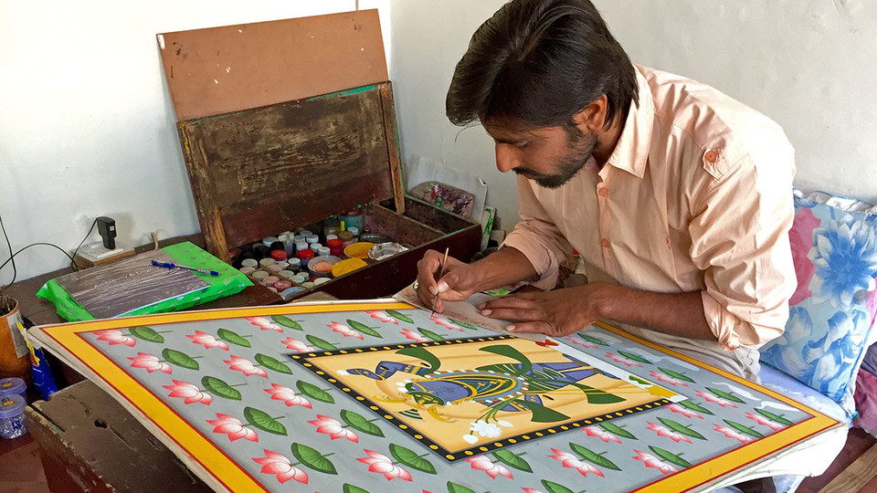  Jatin Sharma of Nathdwara, India, works on a pichvai painting.