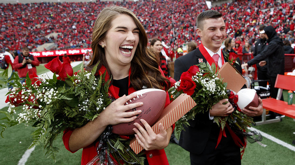 Homecoming queen Monica Rogers laughs as king Gage Hoegermeyer looks on during halftime of the Nebraska-Purdue game Sept. 29. 