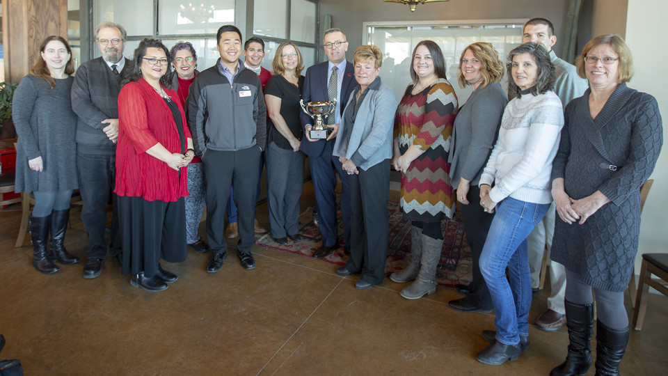 Chancellor Ronnie Green (center, with cup) and volunteers from across campus celebrated a successful 2019 Combined Campaign Dec. 12 at Nebraska Innovation Campus.