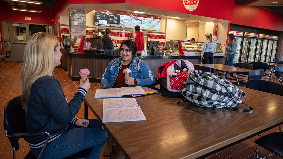Nikki Holthaus, left, a sophomore marketing major from Elkhorn, and Karla Ortiz, a sophomore elementary education major from South Sioux City, enjoy ice cream at the Dairy Store on Feb. 28. A Dairy Store relocation celebration is planned for 2 to 5 p.m. March 12.