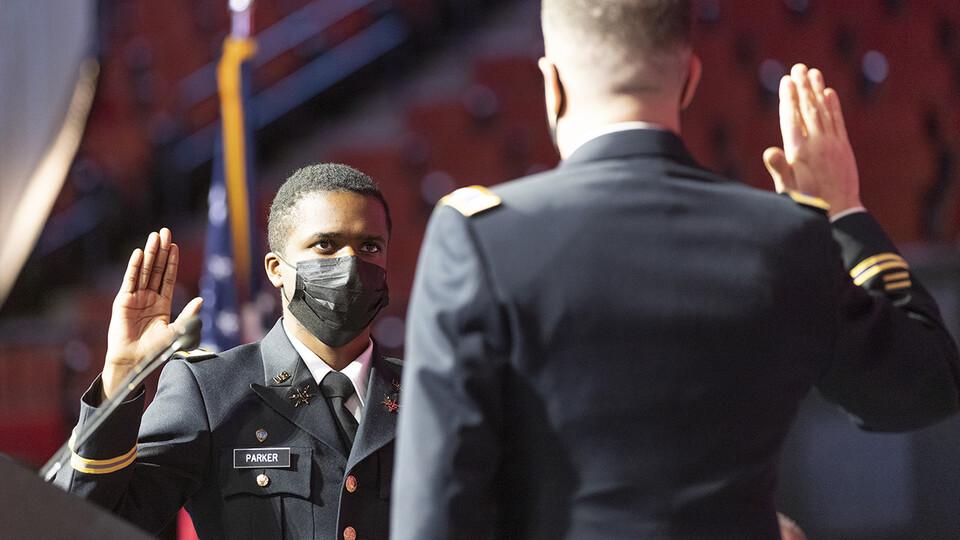 Hunter Parker takes the oath of office during the undergraduate commencement ceremony Dec. 18 at Pinnacle Bank Arena. Col. Thad Fineran, chief of staff of the Nebraska National Guard, administers the oath. Parker was commissioned a second lieutenant in the U.S. Army during a ceremony Dec. 17.