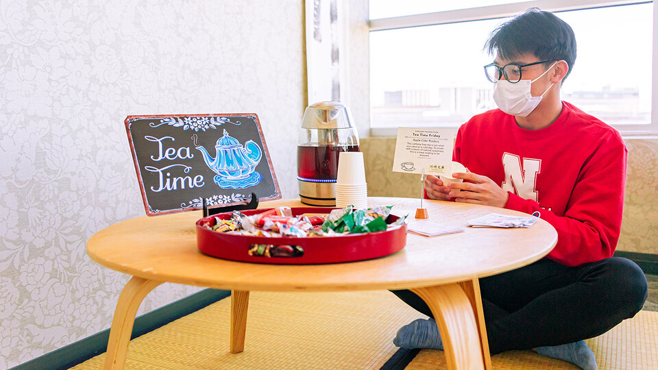 Andre Nguyen sits at the Tea Time Friday table at the Kawasaki Reading Room in the Gaughan Multicultural Center on Feb. 25.