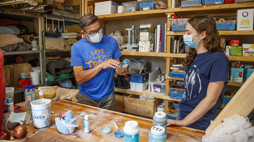 Eddie Dominguez, professor of art, works with UCARE student Kinga Aletto in August 2020. Aletto created a life-size clay model of the Javan blue-banded kingfisher.