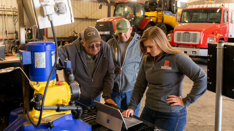 Taylor Cross (right), a graduate student in mechanized systems management, speaks with Nebraska ag producers Doug Jones (left) and Tony Jones about the sensor-based fertigation management technology that’s been shown to increase nitrogen-use efficiency and profitability in on-farm research.