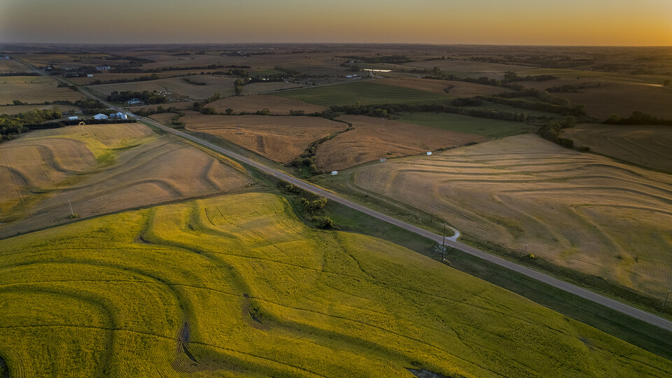 Corn and soybean fields create a patchwork of colors at sunset, bisected by Highway 43 in southeast Lancaster County. The market value of agricultural land in Nebraska increased 14% over the prior year, to an average of $3,835 per acre, according to a University of Nebraska–Lincoln report.