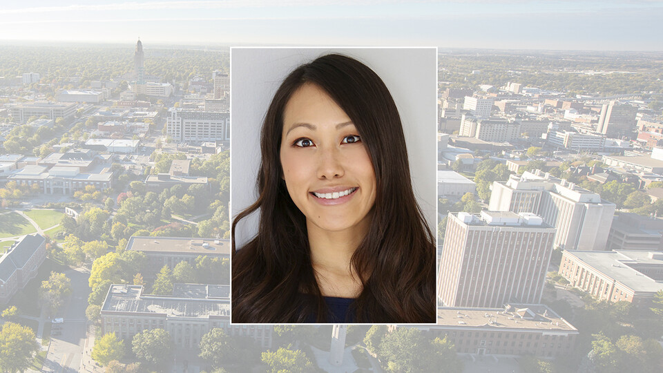 Color portrait of Jane Chen on campus and city background