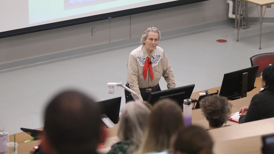 Temple Grandin, professor of animal science at Colorado State University, stands in front of a classroom of 4-H educators.