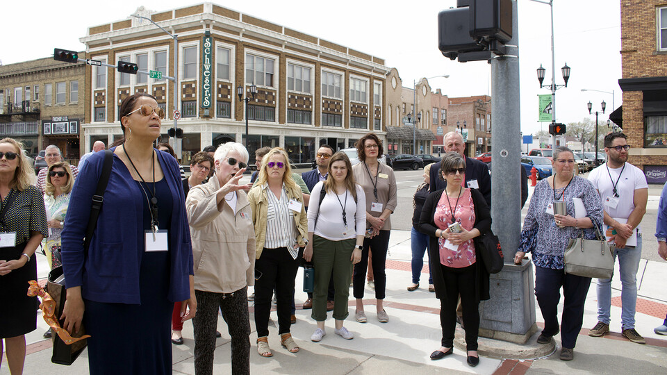 Rural Prosperity Nebraska’s Kim Wilson leads a walking tour of Columbus, highlighting the downtown economic area.
