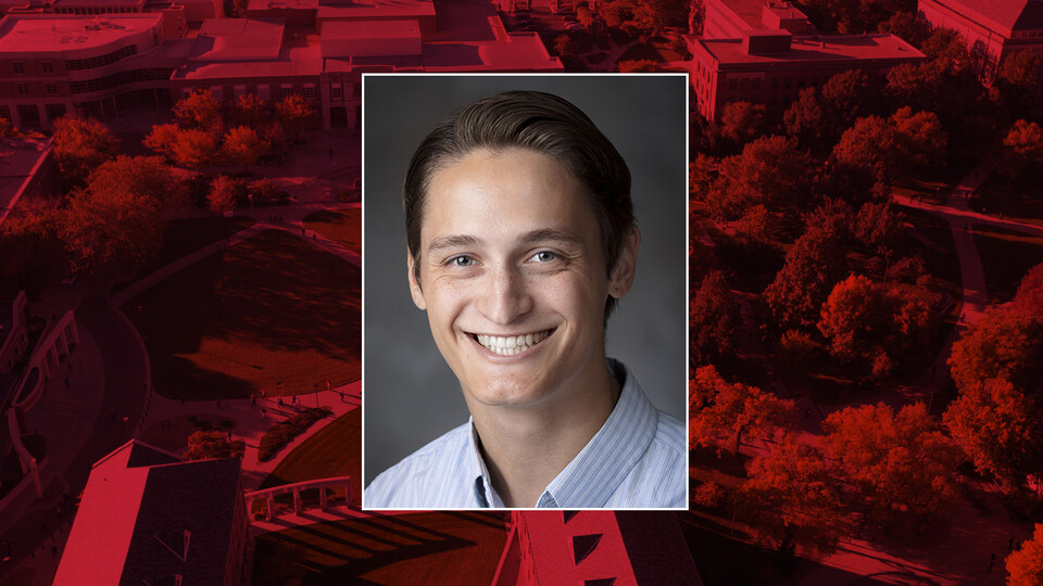 Color portrait of Dwight Miller on red campus background