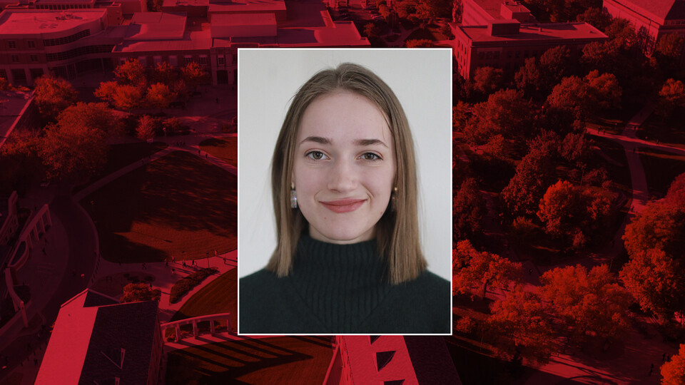 Color portrait of Rachael Lange on red campus background