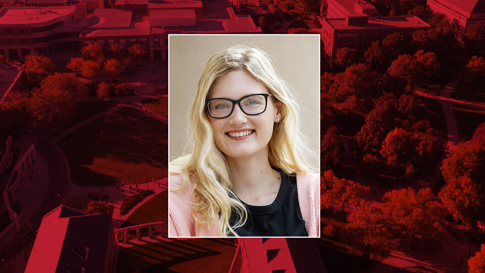 Color portrait of Sadie Ritter on red campus background